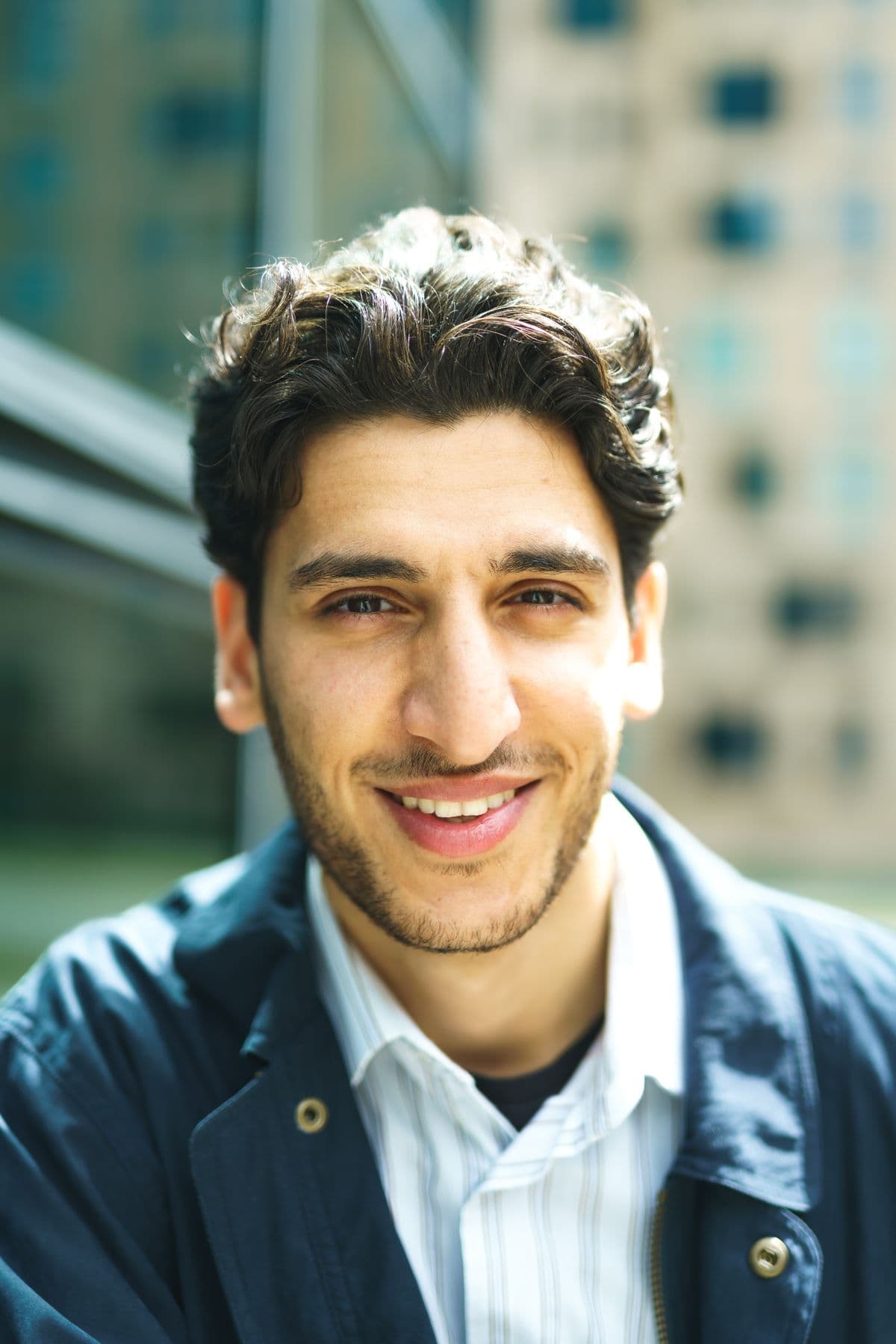 A confident man smiling in natural daylight