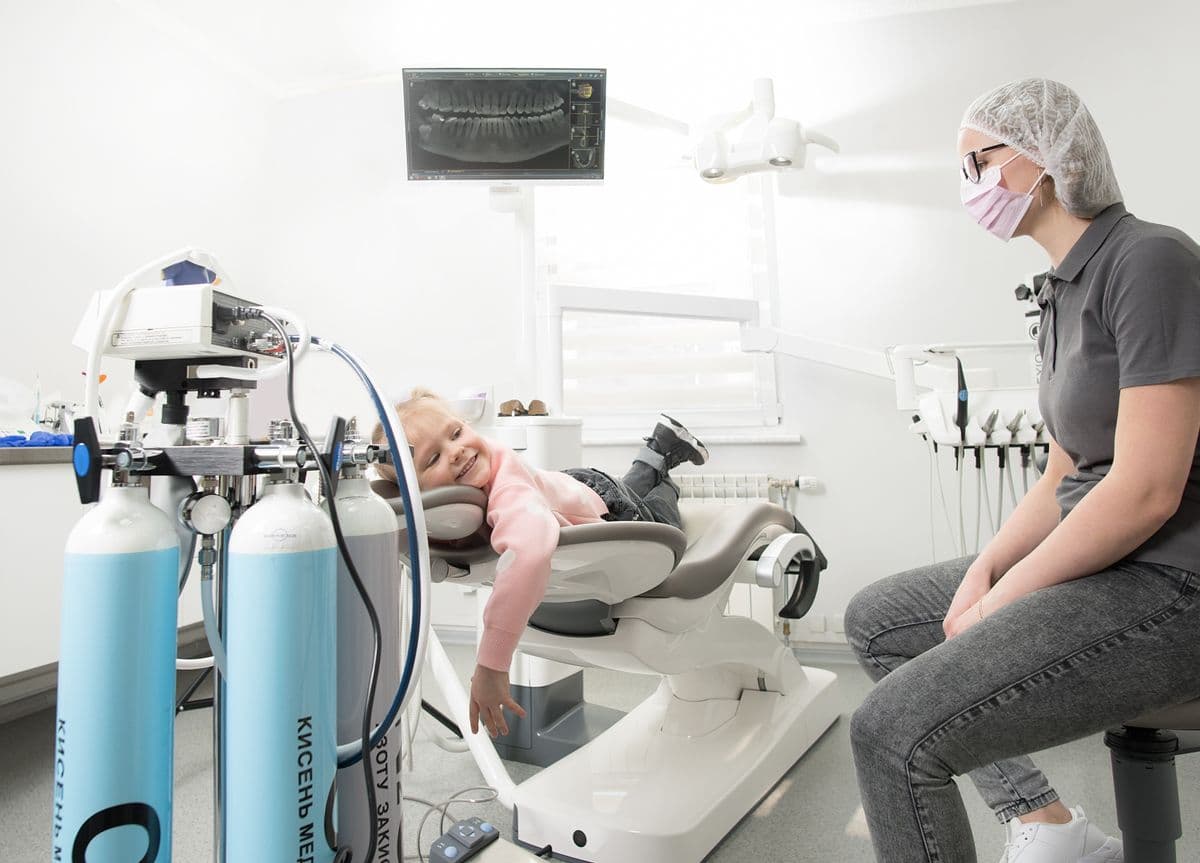 A child smiling at a friendly, modern dental visit