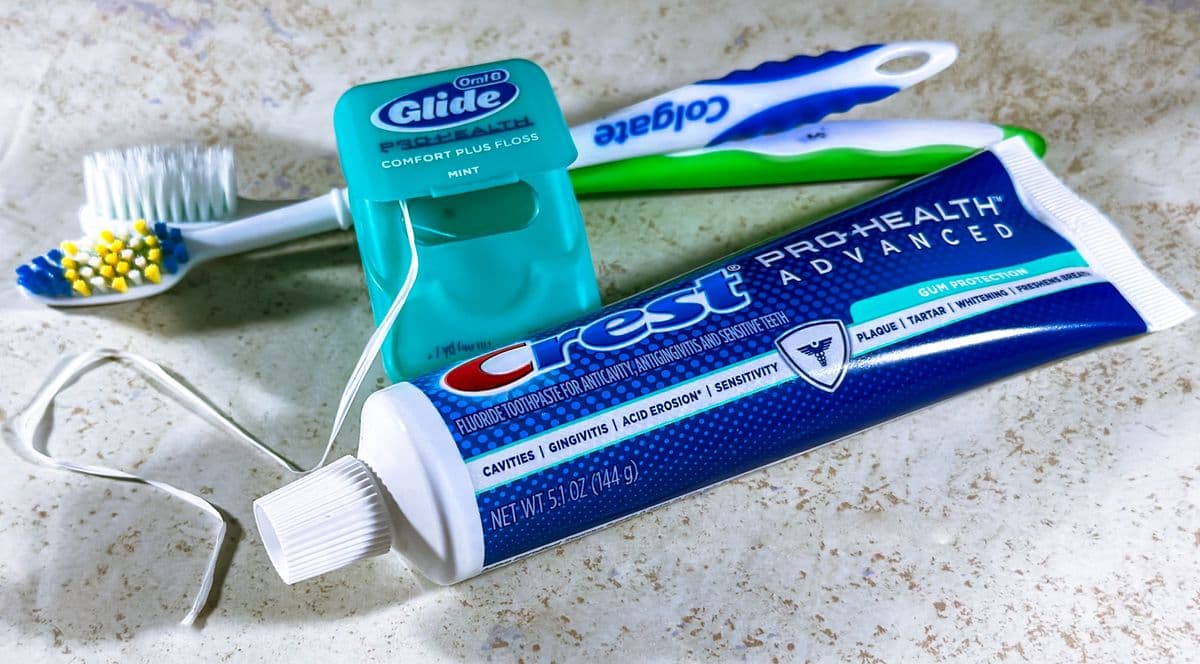 A child brushing their teeth in soft natural light